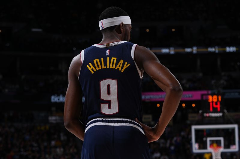 DENVER, CO - MARCH 25: Justin Holiday #9 of the Denver Nuggets looks on during the game against the Memphis Grizzlies on March 25, 2024 at the Ball Arena in Denver, Colorado. NOTE TO USER: User expressly acknowledges and agrees that, by downloading and/or using this Photograph, user is consenting to the terms and conditions of the Getty Images License Agreement. Mandatory Copyright Notice: Copyright 2024 NBAE (Photo by Bart Young/NBAE via Getty Images)