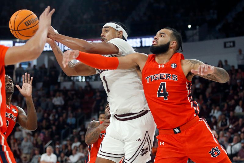 Jan 27, 2024; Starkville, Mississippi, USA; Mississippi State Bulldogs forward Tolu Smith (1) and Auburn Tigers forward/center Johni Broome (4) battle for a rebound during the second half at Humphrey Coliseum. Mandatory Credit: Petre Thomas-USA TODAY Sports