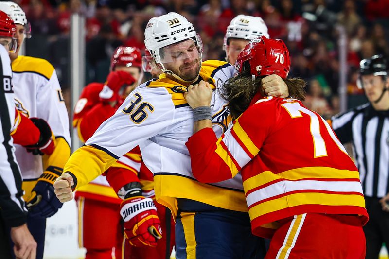 Jan 3, 2026; Calgary, Alberta, CAN; Calgary Flames left wing Ryan Lomberg (70) and Nashville Predators right wing Cole Smith (36) fight during the first period at Scotiabank Saddledome. Mandatory Credit: Sergei Belski-Imagn Images