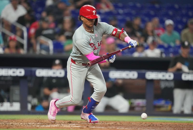 May 12, 2024; Miami, Florida, USA;  Philadelphia Phillies ceter fielder Cristian Pache (19) lays down a bunt in the ninth inn against the Miami Marlins at loanDepot Park. Mandatory Credit: Jim Rassol-USA TODAY Sports