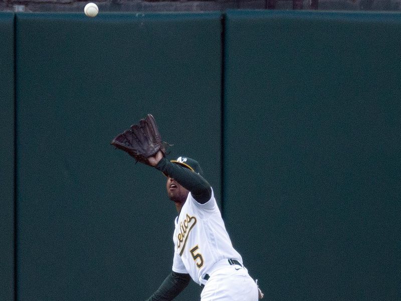 Jun 16, 2023; Oakland, California, USA; Oakland Athletics left fielder Tony Kemp (5) runs down a deep fly ball the first inning at Oakland-Alameda County Coliseum. Mandatory Credit: D. Ross Cameron-USA TODAY Sports