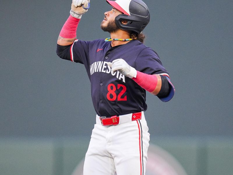 Jun 18, 2024; Minneapolis, Minnesota, USA; Minnesota Twins outfielder Austin Martin (82) celebrates his hit against the Tampa Bay Rays in the third inning at Target Field. Mandatory Credit: Brad Rempel-USA TODAY Sports