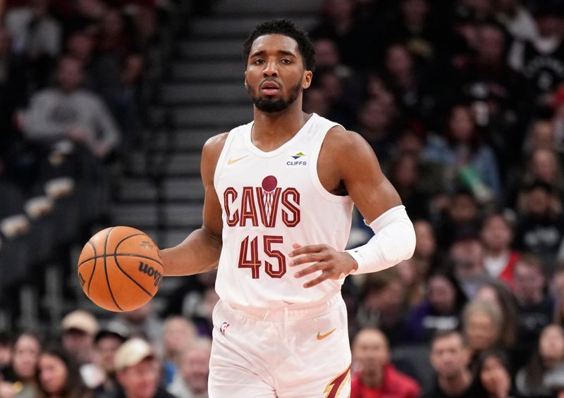 TORONTO, ON - FEBRUARY 10: Donovan Mitchell #45 of the Cleveland Cavaliers dribbles against the Toronto Raptors during the first half of their basketball game at the Scotiabank Arena on February 10, 2024 in Toronto, Ontario, Canada. NOTE TO USER: User expressly acknowledges and agrees that, by downloading and/or using this Photograph, user is consenting to the terms and conditions of the Getty Images License Agreement. (Photo by Mark Blinch/Getty Images)