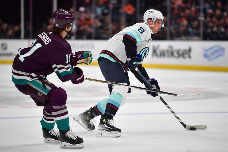 Apr 5, 2024; Anaheim, California, USA; Seattle Kraken defenseman Brian Dumoulin (8) moves the puck against Anaheim Ducks center Trevor Zegras (11) during the first period at Honda Center. Mandatory Credit: Gary A. Vasquez-USA TODAY Sports