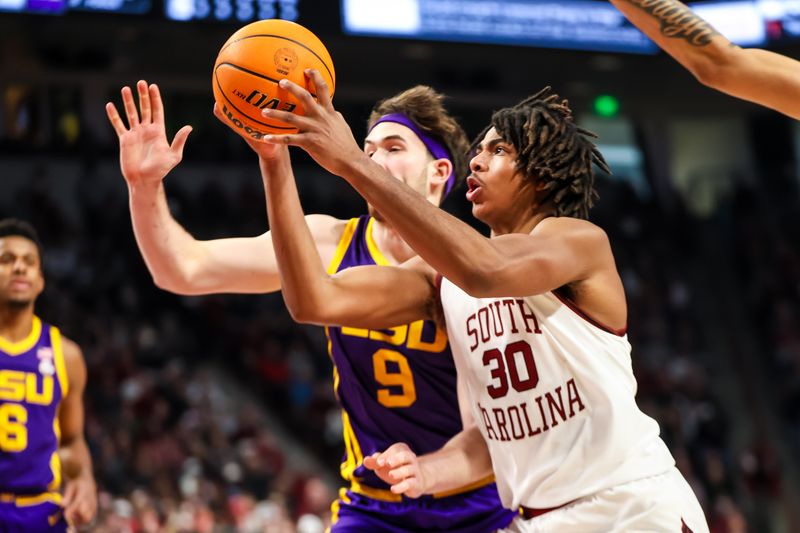 Feb 17, 2024; Columbia, South Carolina, USA; South Carolina Gamecocks forward Collin Murray-Boyles (30) drives past LSU Tigers forward Will Baker (9) in the first half at Colonial Life Arena. Mandatory Credit: Jeff Blake-USA TODAY Sports