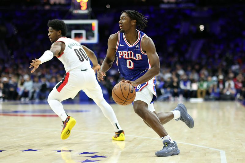 PHILADELPHIA, PENNSYLVANIA - OCTOBER 29: Tyrese Maxey #0 of the Philadelphia 76ers drives past Scoot Henderson #00 of the Portland Trail Blazers during the second quarter at Wells Fargo Center on October 29, 2023 in Philadelphia, Pennsylvania. NOTE TO USER: User expressly acknowledges and agrees that, by downloading and or using this photograph, User is consenting to the terms and conditions of the Getty Images License Agreement. (Photo by Tim Nwachukwu/Getty Images)