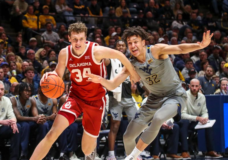 Feb 4, 2023; Morgantown, West Virginia, USA; Oklahoma Sooners forward Jacob Groves (34) drives to the basket against West Virginia Mountaineers forward James Okonkwo (32) during the first half at WVU Coliseum. Mandatory Credit: Ben Queen-USA TODAY Sports