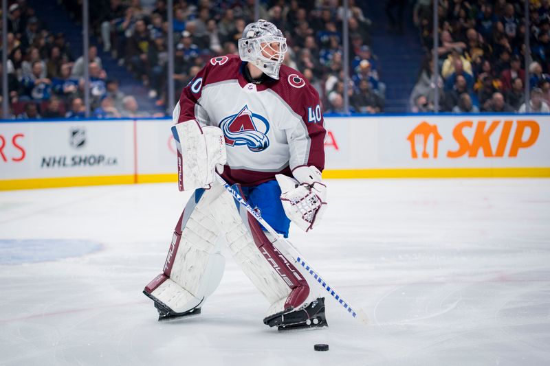 Mar 13, 2024; Vancouver, British Columbia, CAN; Colorado Avalanche goalie Alexandar Georgiev (40) handles the puck against the Vancouver Canucks in the third period at Rogers Arena. Colorado won 4 -3 in overtime. Mandatory Credit: Bob Frid-USA TODAY Sports