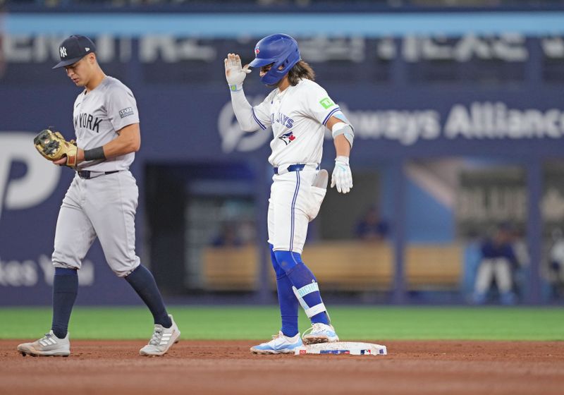 Apr 17, 2024; Toronto, Ontario, CAN; Toronto Blue Jays shortstop Bo Bichette (11) celebrates hitting a double against the New York Yankees during the sixth inning at Rogers Centre. Mandatory Credit: Nick Turchiaro-USA TODAY Sports