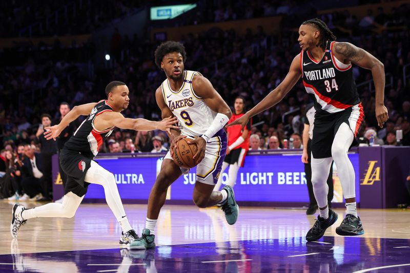 LOS ANGELES, CALIFORNIA - DECEMBER 08: Bronny James #9 of the Los Angeles Lakers drives with the ball against Jabari Walker #34 and Bryce McGowens #11 of the Portland Trail Blazers in the second half at Crypto.com Arena on December 08, 2024 in Los Angeles, California. NOTE TO USER: User expressly acknowledges and agrees that, by downloading and or using this Photograph, user is consenting to the terms and conditions of the Getty Images License Agreement. (Photo by Meg Oliphant/Getty Images)