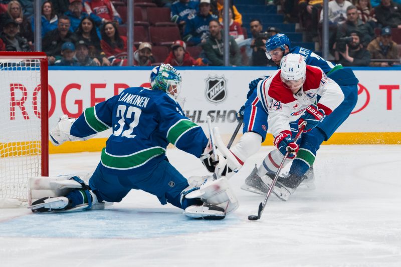 Mar 11, 2025; Vancouver, British Columbia, CAN; Vancouver Canucks defenseman Marcus Pettersson (29) watches as Montreal Canadiens forward Nick Suzuki (14) scores on goalie Kevin Lankinen (32) in the first period at Rogers Arena. Mandatory Credit: Bob Frid-Imagn Images