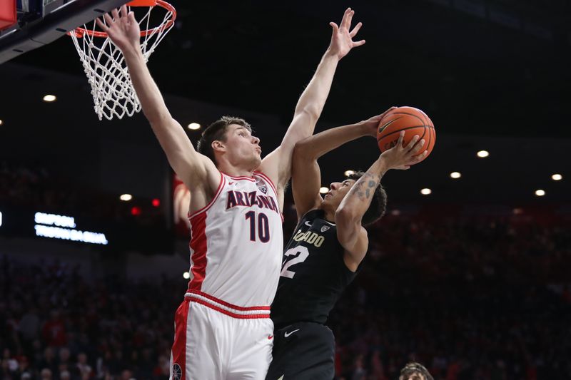 Feb 18, 2023; Tucson, Arizona, USA; Colorado Buffaloes guard Nique Clifford (32) makes a basket against Arizona Wildcats forward Azuolas Tubelis (10)  during the first half at McKale Center. Mandatory Credit: Zachary BonDurant-USA TODAY Sports