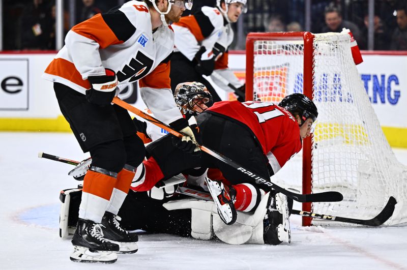 Apr 13, 2024; Philadelphia, Pennsylvania, USA; New Jersey Devils center Dawson Mercer (91) falls on Philadelphia Flyers goalie Samuel Ersson (33) in the second period at Wells Fargo Center. Mandatory Credit: Kyle Ross-USA TODAY Sports