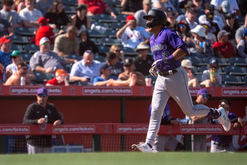 Mar 8, 2024; Tempe, Arizona, USA; Colorado Rockies infielder Alan Trejo (13) comes in to score after a home run in the seventh during a spring training game against the Los Angeles Angels at Tempe Diablo Stadium. Mandatory Credit: Allan Henry-USA TODAY Sports