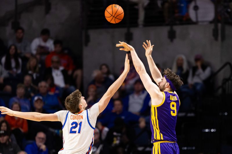 Feb 13, 2024; Gainesville, Florida, USA; Florida Gators forward Alex Condon (21) attempts to block the shot from LSU Tigers forward Will Baker (9) during the second half at Exactech Arena at the Stephen C. O'Connell Center. Mandatory Credit: Matt Pendleton-USA TODAY Sports