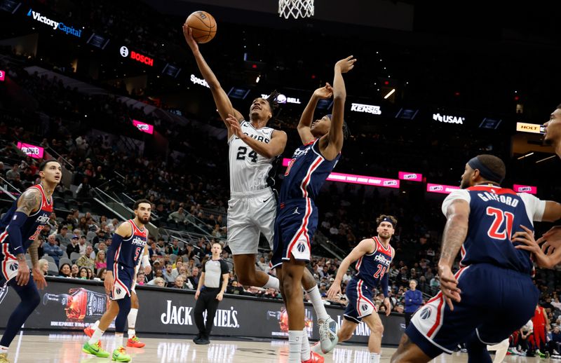 SAN ANTONIO, TX - JANUARY  29:  Devin Vassell #24 of the San Antonio Spurs puts up a shot against Bilal Coulibaly #0 of the Washington Wizards in the first half at Frost Bank Center on January 29, 2024 in San Antonio, Texas. NOTE TO USER: User expressly acknowledges and agrees that, by downloading and or using this photograph, User is consenting to terms and conditions of the Getty Images License Agreement. (Photo by Ronald Cortes/Getty Images)