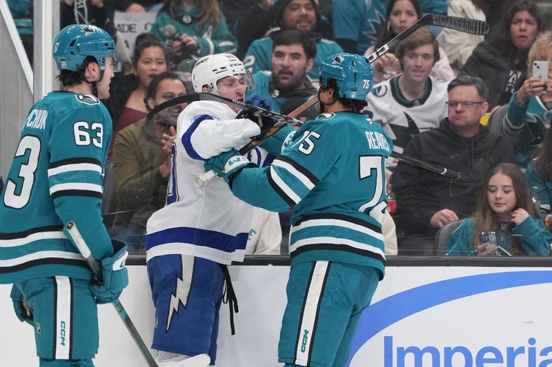 Jan 3, 2026; San Jose, California, USA; Tampa Bay Lightning defenseman J.J. Moser (center left) and San Jose Sharks right wing Ryan Reaves (center right) fight during the second period at SAP Center at San Jose. Mandatory Credit: Darren Yamashita-Imagn Images