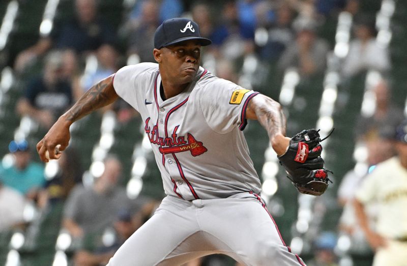 Jul 30, 2024; Milwaukee, Wisconsin, USA; Atlanta Braves pitcher Raisel Iglesias (26) delivers a pitch against the Milwaukee Brewers in the ninth inning at American Family Field. Mandatory Credit: Michael McLoone-USA TODAY Sports