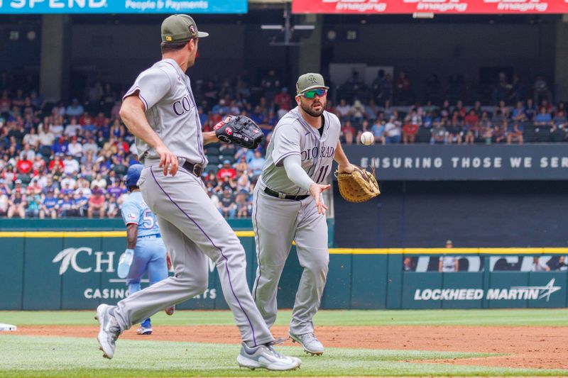 May 21, 2023; Arlington, Texas, USA; Colorado Rockies first baseman Mike Moustakas (11) tosses over to Colorado Rockies starting pitcher Connor Seabold (43) during the fourth inning against the Texas Rangers at Globe Life Field. Mandatory Credit: Andrew Dieb-USA TODAY Sports