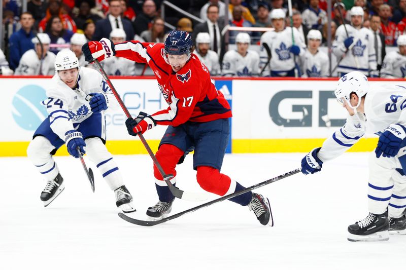 Mar 20, 2024; Washington, District of Columbia, USA; Washington Capitals center Dylan Strome (17) controls the puck as Toronto Maple Leafs center Connor Dewar (24) defends during the third period at Capital One Arena. Mandatory Credit: Amber Searls-USA TODAY Sports