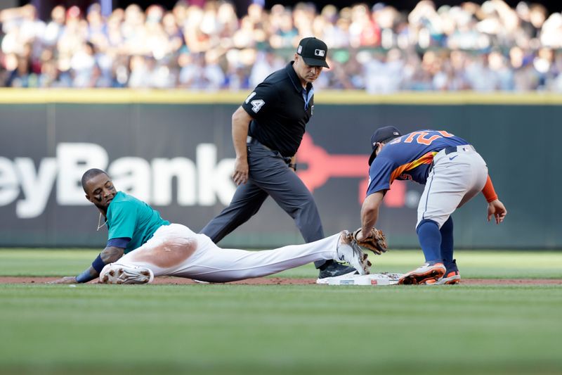 Jul 20, 2024; Seattle, Washington, USA; Seattle Mariners left fielder Victor Robles (10) steals second base against Houston Astros second baseman Jose Altuve (27) during the first inning at T-Mobile Park. Mandatory Credit: John Froschauer-USA TODAY Sports