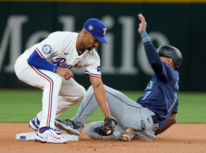 Apr 24, 2024; Arlington, Texas, USA; Seattle Mariners second base Jorge Polanco (7) is forced out at second base by Texas Rangers second baseman Marcus Semien (2)during the first inning at Globe Life Field. Mandatory Credit: Jim Cowsert-USA TODAY Sports