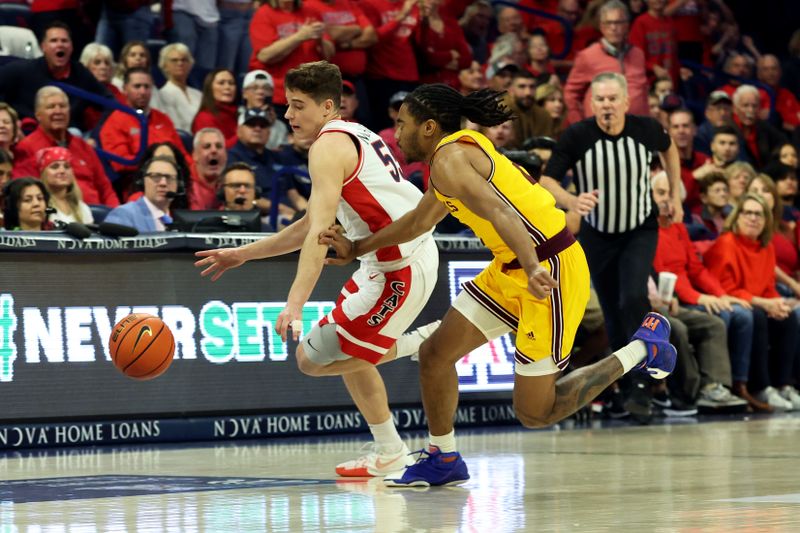 Feb 17, 2024; Tucson, Arizona, USA; Arizona Wildcats guard Conrad Martinez (55) steels the ball away from Arizona State Sun Devils guard Braelon Green (2) during the second half at McKale Center. Mandatory Credit: Zachary BonDurant-USA TODAY Sports