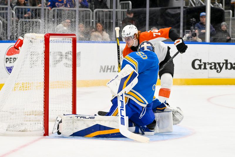 Nov 30, 2024; St. Louis, Missouri, USA;  Philadelphia Flyers right wing Owen Tippett (74) shoots and scores against St. Louis Blues goaltender Jordan Binnington (50) during the first period at Enterprise Center. Mandatory Credit: Jeff Curry-Imagn Images