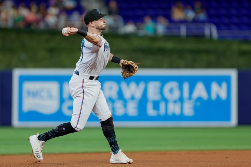 Jun 21, 2023; Miami, Florida, USA; Miami Marlins third baseman Garrett Hampson (1) throws the baseball to first baseman Garrett Cooper (not pictured) to retire right fielder George Springer (not pictured) during the first inning at loanDepot Park. Mandatory Credit: Sam Navarro-USA TODAY Sports