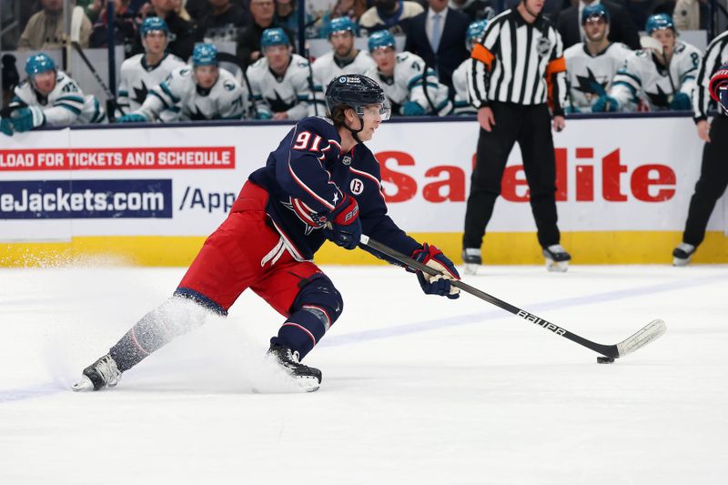 Jan 16, 2025; Columbus, Ohio, USA;   Columbus Blue Jackets center Kent Johnson (91) controls the puck during the first period against the San Jose Sharks at Nationwide Arena. Mandatory Credit: Joseph Maiorana-Imagn Images