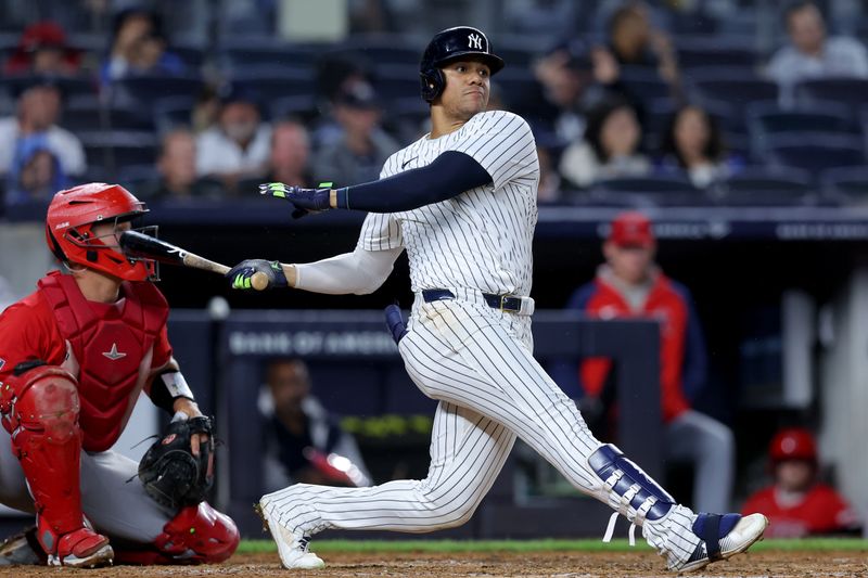 Aug 7, 2024; Bronx, New York, USA; New York Yankees right fielder Juan Soto (22) follows through on a single against the Los Angeles Angels during the third inning at Yankee Stadium. Mandatory Credit: Brad Penner-USA TODAY Sports