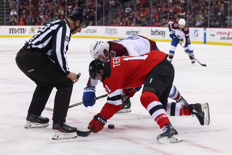 Feb 6, 2024; Newark, New Jersey, USA; New Jersey Devils center Chris Tierney (11) and Colorado Avalanche center Ryan Johansen (12) face-off during the first period at Prudential Center. Mandatory Credit: Ed Mulholland-USA TODAY Sports