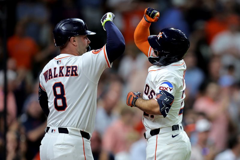 May 22, 2025; Houston, Texas, USA; Houston Astros left fielder Jose Altuve (27) is congratulated by Houston Astros first baseman Christian Walker (8) after hitting a solo home run against the Seattle Mariners during the fifth inning at Daikin Park. Mandatory Credit: Erik Williams-Imagn Images