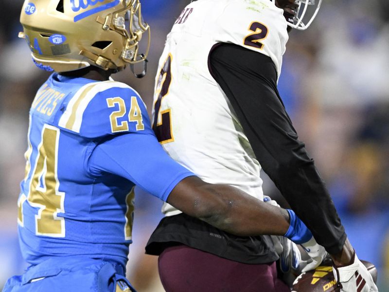 Nov 11, 2023; Pasadena, California, USA;  Arizona State Sun Devils wide receiver Elijhah Badger (2) catches a touchdown pass against UCLA Bruins defensive back Jaylin Davies (24) during the second half at the Rose Bowl. Mandatory Credit: Alex Gallardo-USA TODAY Sports