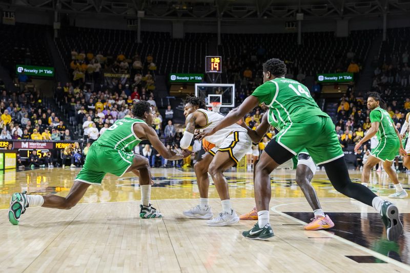 Jan 29, 2025; Wichita, Kansas, USA;  Wichita State Shockers guard Justin Hill (11) protect the ball during the second half against the North Texas Mean Green at Charles Koch Arena. Mandatory Credit: William Purnell-Imagn Images