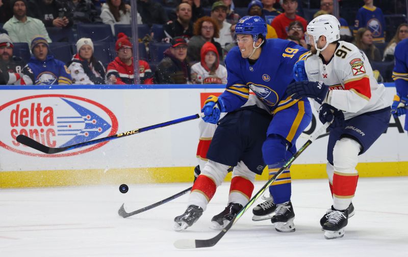 Feb 15, 2024; Buffalo, New York, USA;  Buffalo Sabres center Peyton Krebs (19) gets checked as he carries the puck during the second period against the Florida Panthers at KeyBank Center. Mandatory Credit: Timothy T. Ludwig-USA TODAY Sports