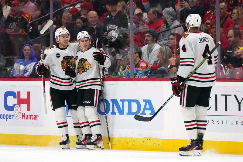 Nov 12, 2023; Sunrise, Florida, USA; Chicago Blackhawks center Connor Bedard (98) celebrates his goal against the Florida Panthers with teammates on the ice during the second period at Amerant Bank Arena. Mandatory Credit: Jasen Vinlove-USA TODAY Sports