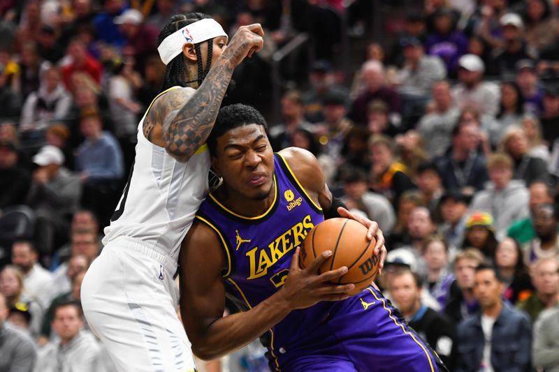 SALT LAKE CITY, UTAH - JANUARY 13: Rui Hachimura #28 of the Los Angeles Lakers drives into Jordan Clarkson #00 of the Utah Jazz during the second half of a game at Delta Center on January 13, 2024 in Salt Lake City, Utah. NOTE TO USER: User expressly acknowledges and agrees that, by downloading and or using this photograph, User is consenting to the terms and conditions of the Getty Images License Agreement. (Photo by Alex Goodlett/Getty Images)