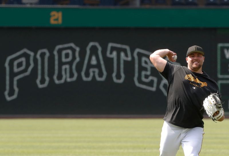 Jul 16, 2023; Pittsburgh, Pennsylvania, USA; Pittsburgh Pirates relief pitcher David Bednar (51) warms up in the outfield before the game against the San Francisco Giants at PNC Park. Mandatory Credit: Charles LeClaire-USA TODAY Sports