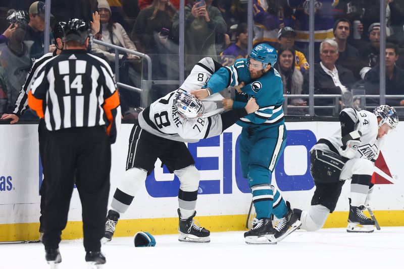 Dec 27, 2023; Los Angeles, California, USA; San Jose Sharks center Luke Kunin (11) and Los Angeles Kings right wing Alex Laferriere (78) fight during the third period of a game at Crypto.com Arena. Mandatory Credit: Jessica Alcheh-USA TODAY Sports