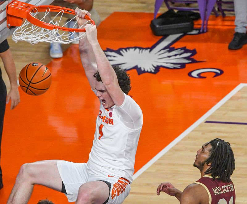 Jan 13, 2024; Clemson, South Carolina, USA; Clemson Tigers forward Ian Schieffelin (4) dunks against Boston College Eagles forward Devin McGlockton (21) during the first half at Littlejohn Coliseum. Mandatory Credit: Ken Ruinard-USA TODAY Sports