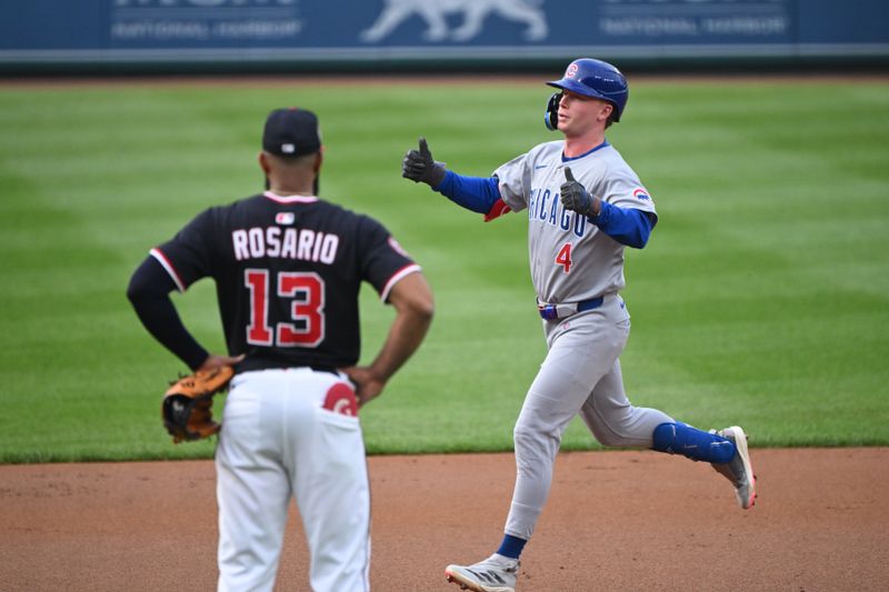 Jun 5, 2025; Washington, District of Columbia, USA; Chicago Cubs center fielder Pete Crow-Armstrong (4) celebrates after hitting a home run as Washington Nationals third baseman Amed Rosario (13) looks on during the first inning against the Washington Nationals at Nationals Park. Mandatory Credit: Rafael Suanes-Imagn Images