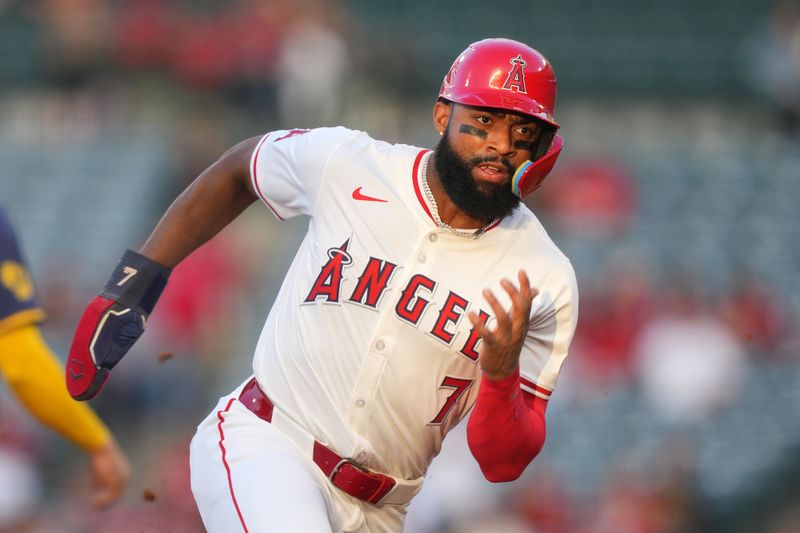 Jun 17, 2024; Anaheim, California, USA; Los Angeles Angels right fielder Jo Adell (7) rounds third base to score in the third inning against the Milwaukee Brewers at Angel Stadium. Mandatory Credit: Kirby Lee-USA TODAY Sports