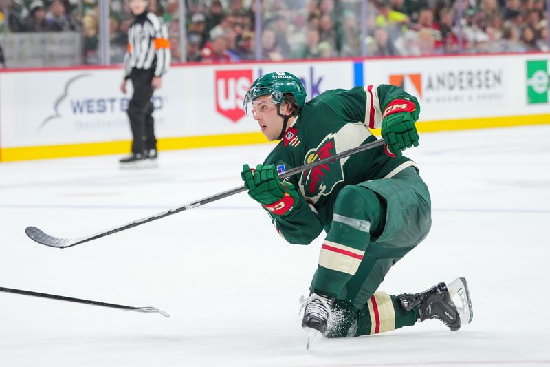 Nov 5, 2024; Saint Paul, Minnesota, USA; Minnesota Wild defenseman Brock Faber (7) shoots against the Los Angeles Kings in the second period at Xcel Energy Center. Mandatory Credit: Brad Rempel-Imagn Images