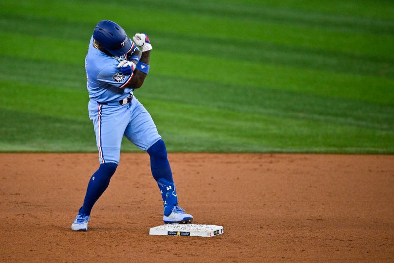 Sep 1, 2024; Arlington, Texas, USA; Texas Rangers right fielder Adolis Garcia (53) celebrates at second base after he hits a double and drives in a run against the Oakland Athletics during the first inning at Globe Life Field. Mandatory Credit: Jerome Miron-USA TODAY Sports