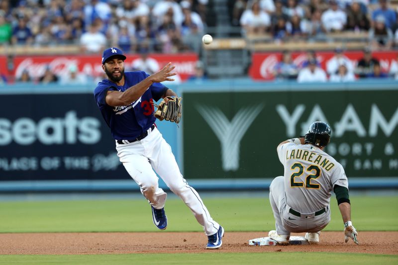 Aug 3, 2023; Los Angeles, California, USA;  Oakland Athletics right fielder Ramon Laureano (22) is out at second as Los Angeles Dodgers second baseman Amed Rosario (31) throws to first to complete a double play in the first inning at Dodger Stadium. Mandatory Credit: Kiyoshi Mio-USA TODAY Sports