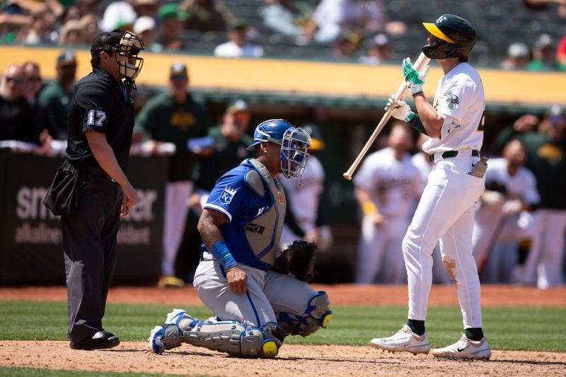 Jun 20, 2024; Oakland, California, USA; Oakland Athletics second baseman Zack Gelof (20) disputes a called third strike with home plate umpire D.J. Reyburn (17) while Kansas City Royals catcher Salvador Perez (13) sits by during the ninth inning at Oakland-Alameda County Coliseum. Mandatory Credit: D. Ross Cameron-USA TODAY Sports