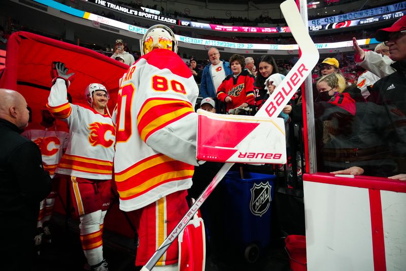 Mar 10, 2024; Raleigh, North Carolina, USA;  Calgary Flames goaltender Dan Vladar (80) and center Mikael Backlund (11) get ready for the warmups against the Carolina Hurricanes at PNC Arena. Mandatory Credit: James Guillory-USA TODAY Sports