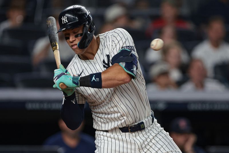 Sep 13, 2024; Bronx, New York, USA; New York Yankees center fielder Aaron Judge (99) avoids a high pitch during the third inning against the Boston Red Sox at Yankee Stadium. Mandatory Credit: Vincent Carchietta-Imagn Images