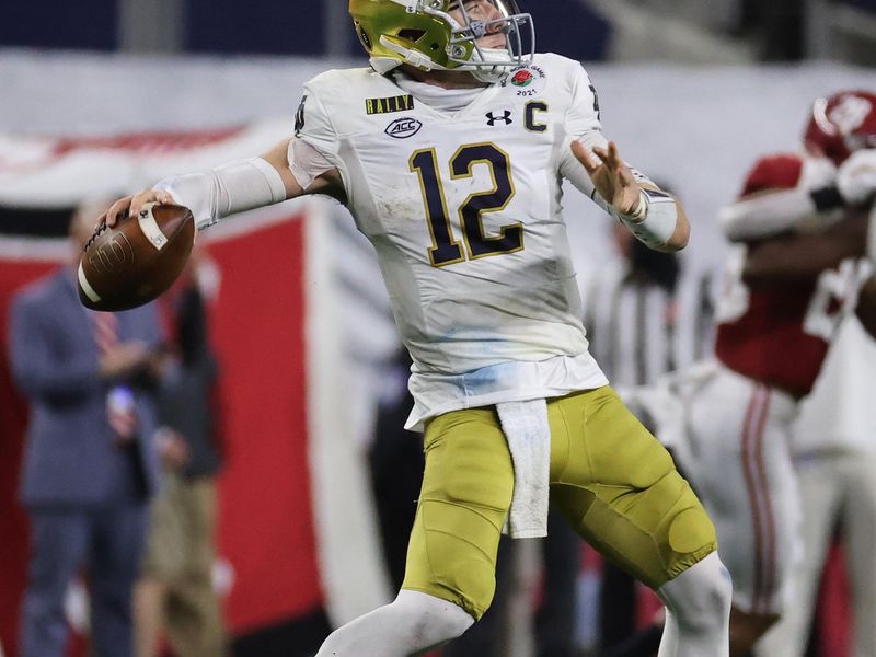 Jan 1, 2021; Arlington, TX, USA; Notre Dame Fighting Irish quarterback Ian Book (12) throws against the Alabama Crimson Tide during the second half in the Rose Bowl at AT&T Stadium. Mandatory Credit: Kevin Jairaj-USA TODAY Sports